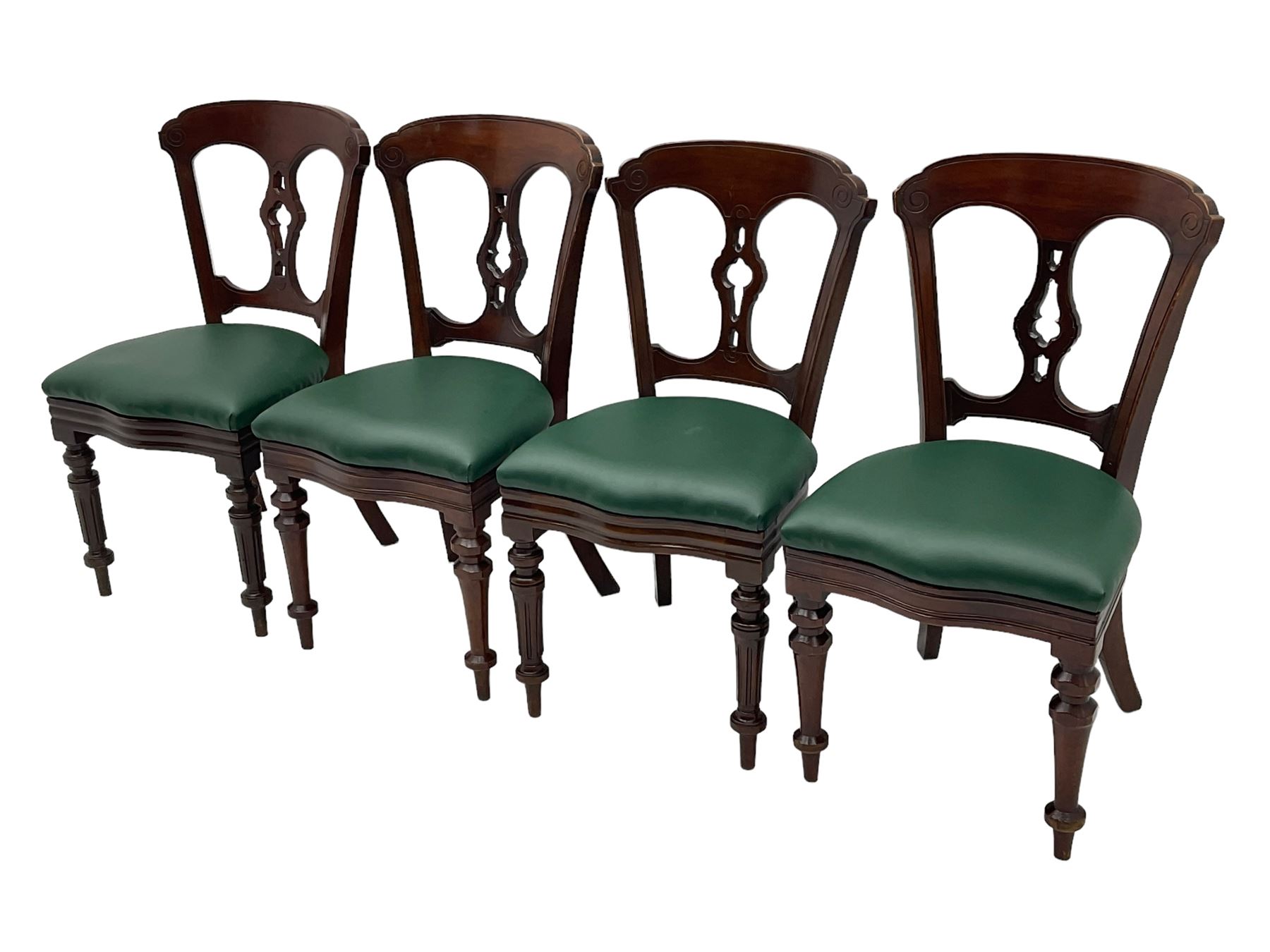 Matched set of twelve Victorian mahogany dining or boardroom chairs, the shaped cresting rail decorated with scrolled decoration, upholstered drop-on seats upholstered in green fabric, on turned supports  