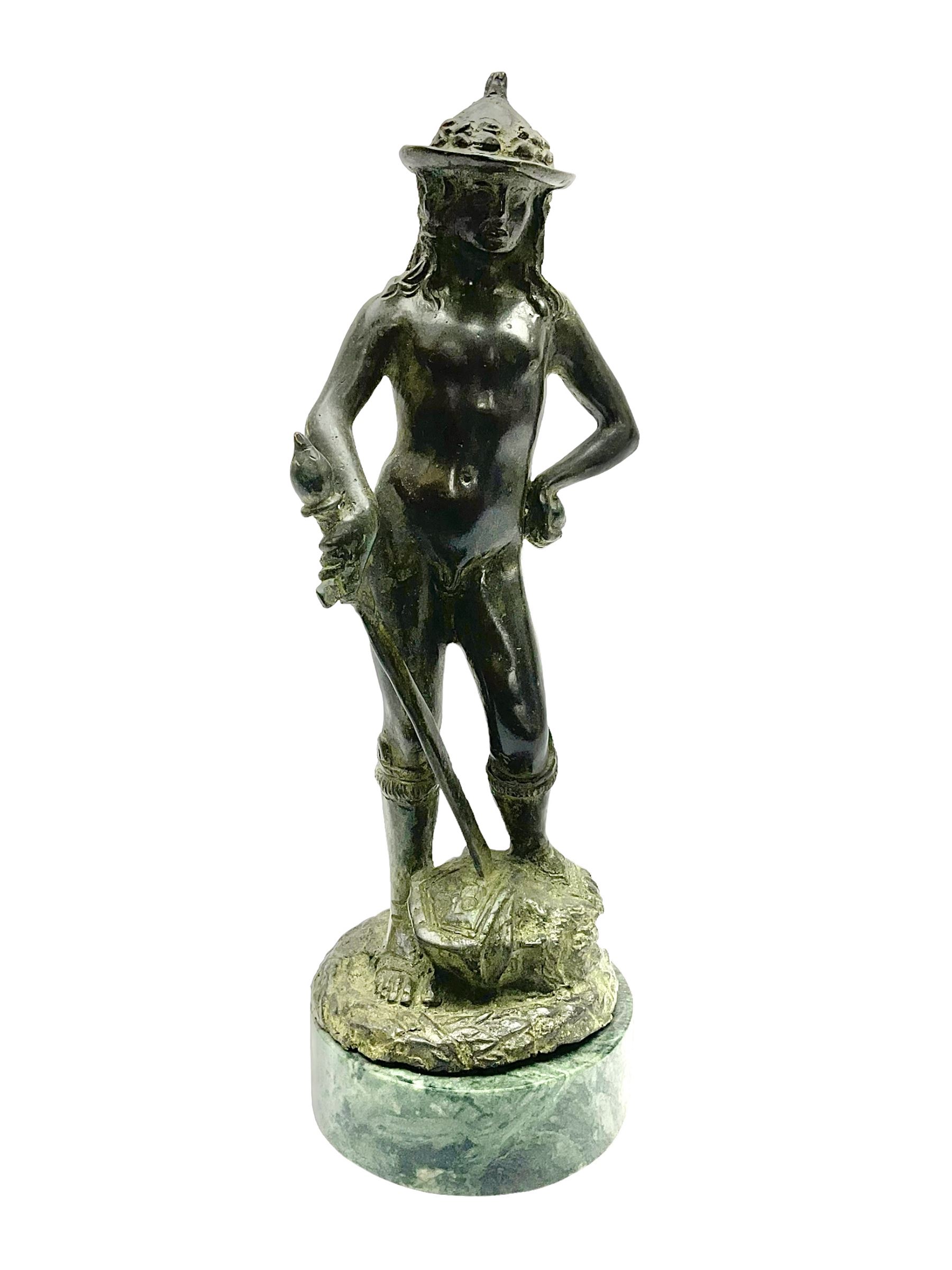 After Donatello, bronzed figure, David with the head of Goliath, upon a circular marble base 