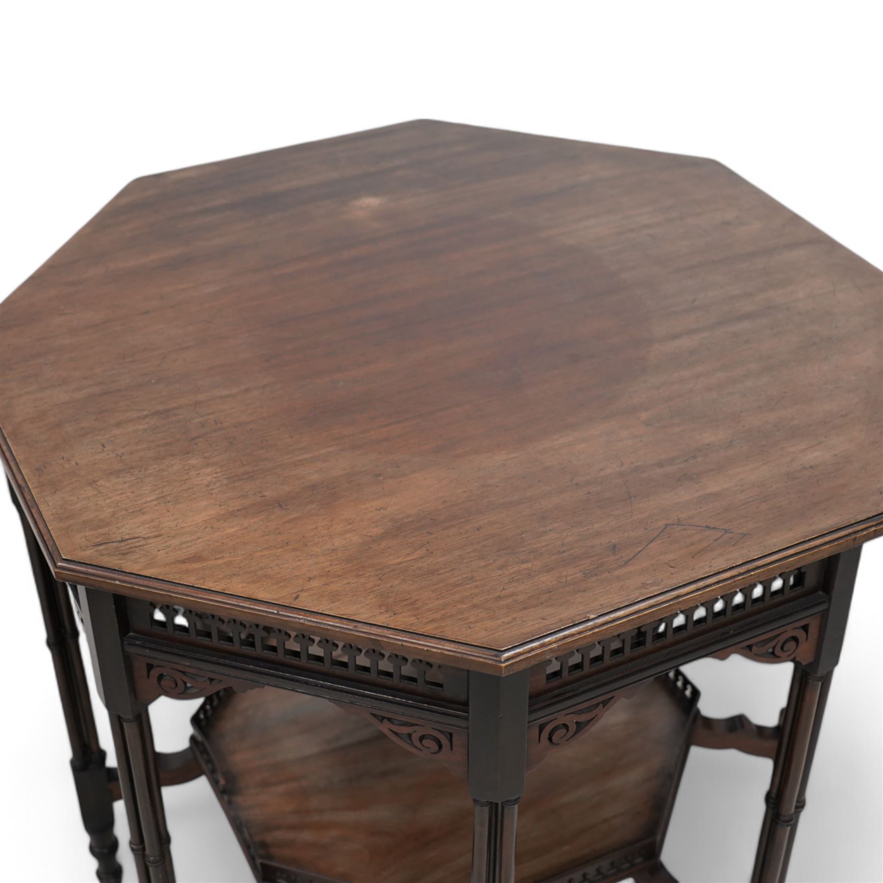 Late 19th to early 20th century mahogany octagonal centre table, moulded top over pierced arcade frieze rails and fretwork brackets, on eight cluster column supports terminating to turned feet, united by under tier with raised gallery 