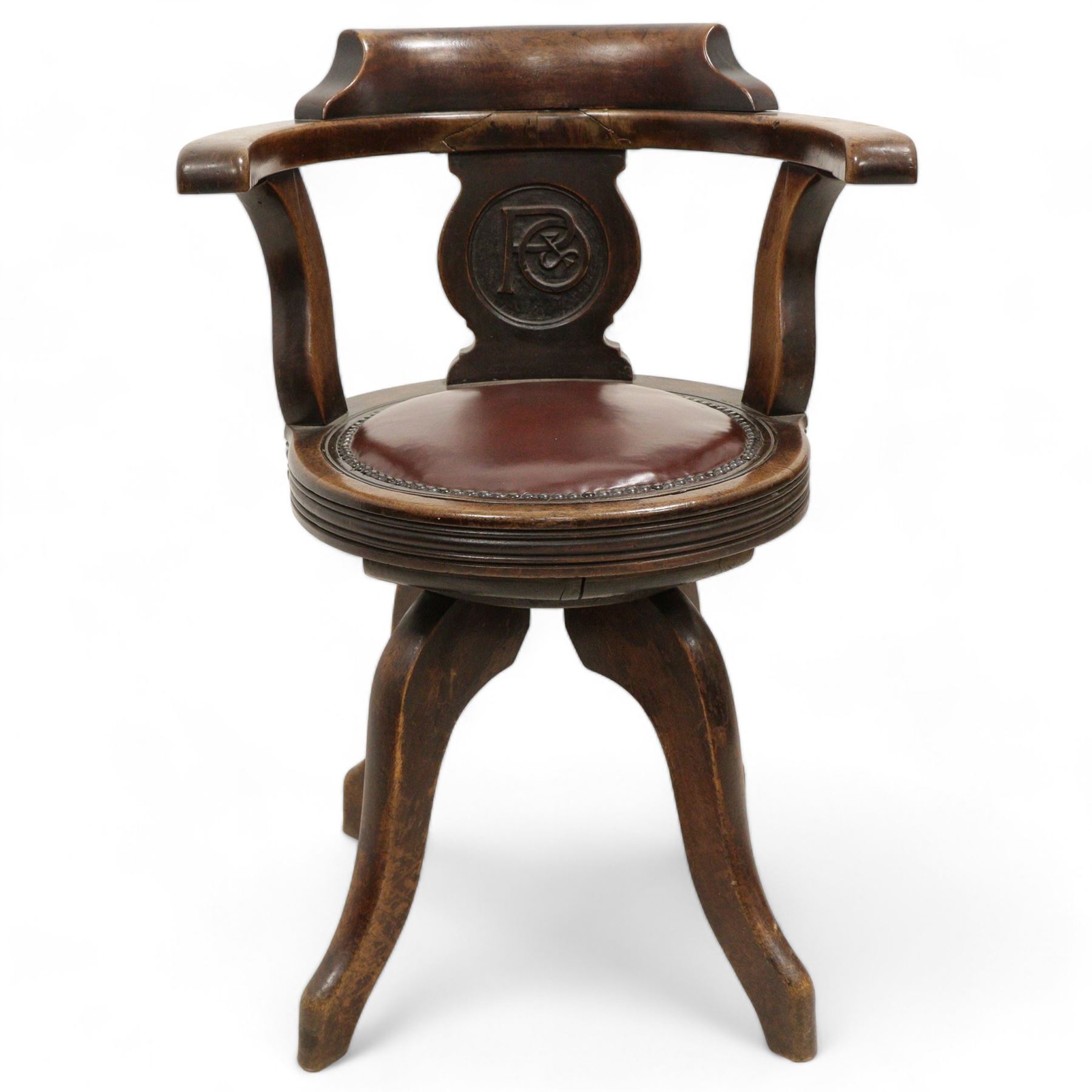 Early 20th century walnut 'P&O' swivel desk chair, curved back over shaped splat carved with monogram 'P&O', circular moulded seat with leather upholstery and stud band, on four high shaped and splayed supports