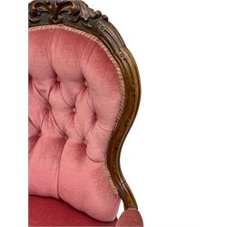 Victorian carved walnut open armchair, foliate carved cresting rail over butted back and sprung seat, upholstered in pink velvet scrolled arm terminals with moulded scrolling vines terminating to cabriole supports and ceramic castors