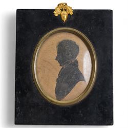 Two 19th century oval silhouettes of members of the Hamilton family, possibly Henry Hamilton (Irish c.1780-1850) and Sackville Hamilton (Irish 1732-1818), in ebonised frames; together with another similar with hand-colouring, indistinctly inscribed verso 13cm x 11cm (3)