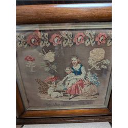 Victorian sampler, depicting woman and young child feeding rabbits, worked by Mary Ann Siswick 1849, set within an oak fire screen, fire screen H75.5cm