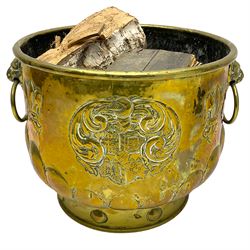 Early 20th century cylindrical brass coal or log bin, embossed with crest and fleur-de-lis motifs, gadrooned underbelly 