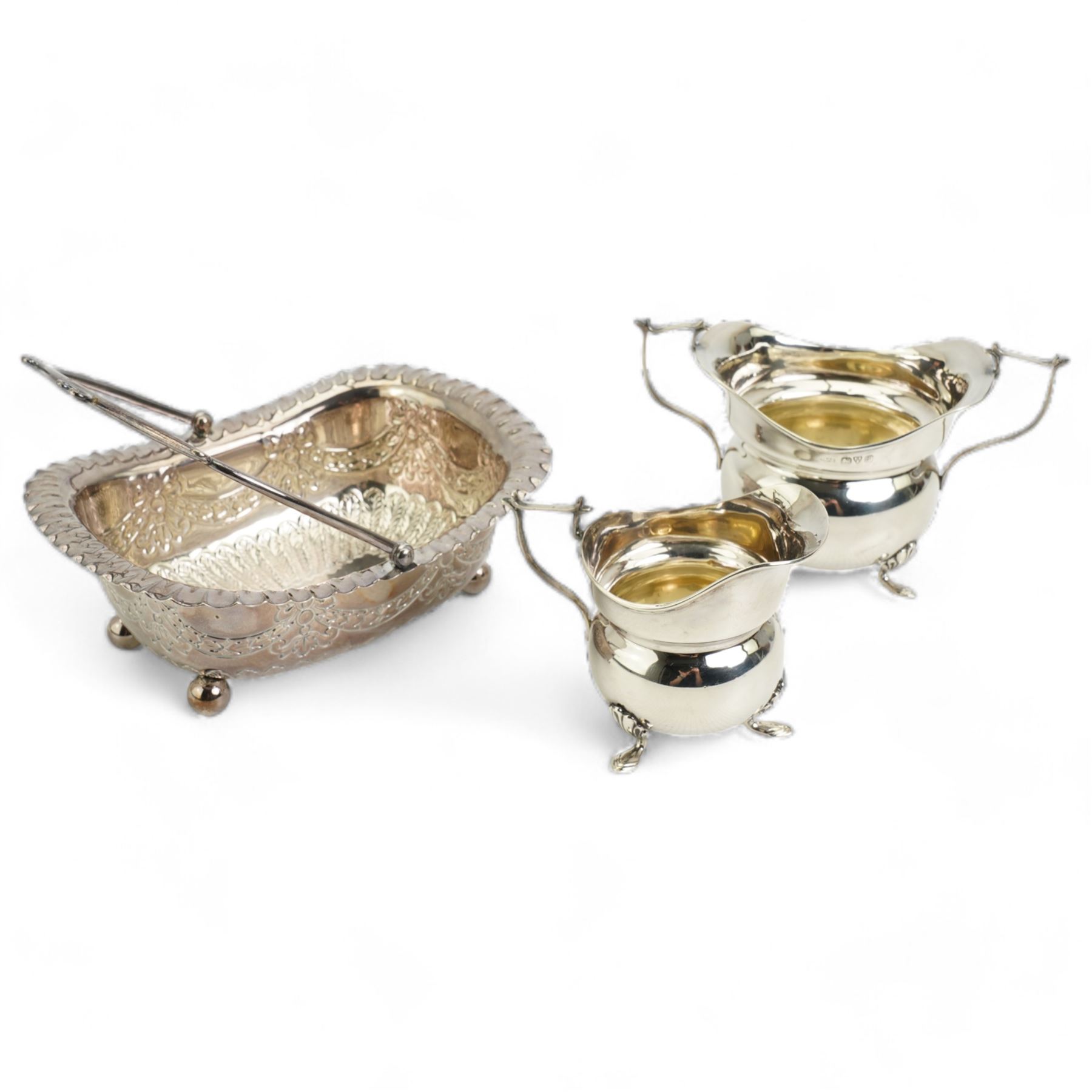  Victorian silver rectangular sugar basket with swing handle decorated with garlands and foliage on ball feet W15cm Sheffield 1891 Maker James Dixon & Son and a silver cream jug and sugar bowl Chester 1919 