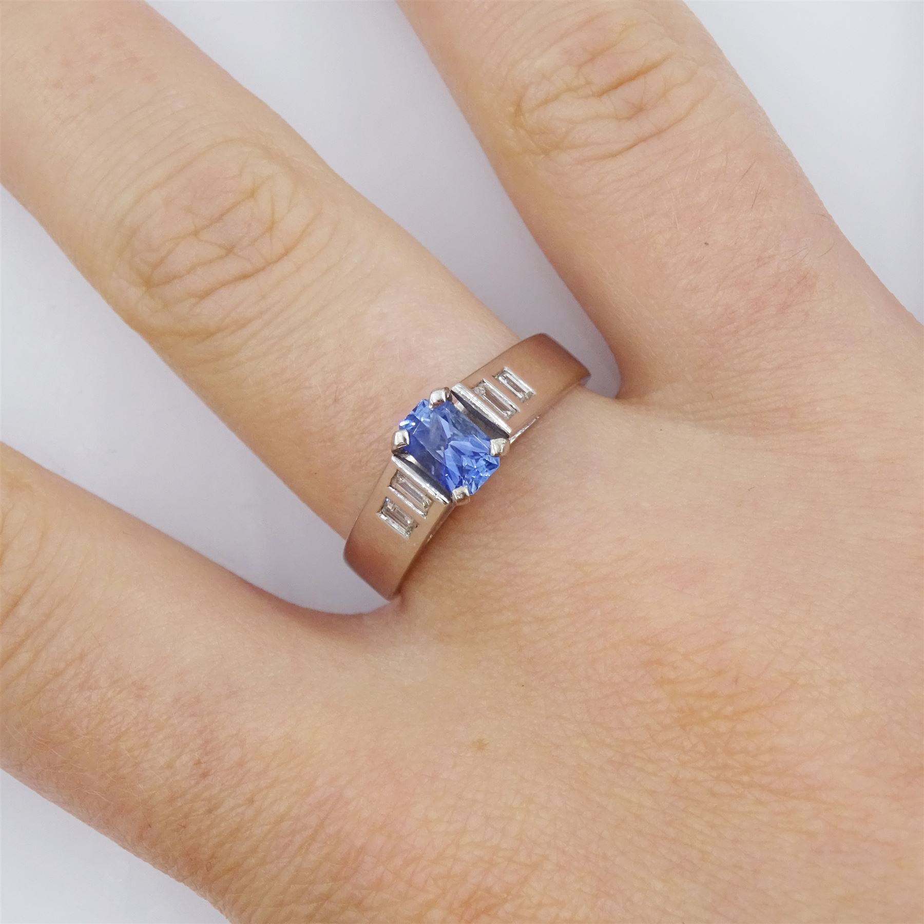 White gold single stone radiant cut sapphire ring, with baguette diamond shoulders, hallmarked 9ct, sapphire approx 0.65 carat