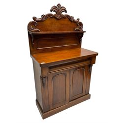 Victorian mahogany chiffonier, raised back with carved C-scroll foliage mounts and shelf, rectangular top with rounded corners over frieze drawer and double panelled cupboard, on skirted base