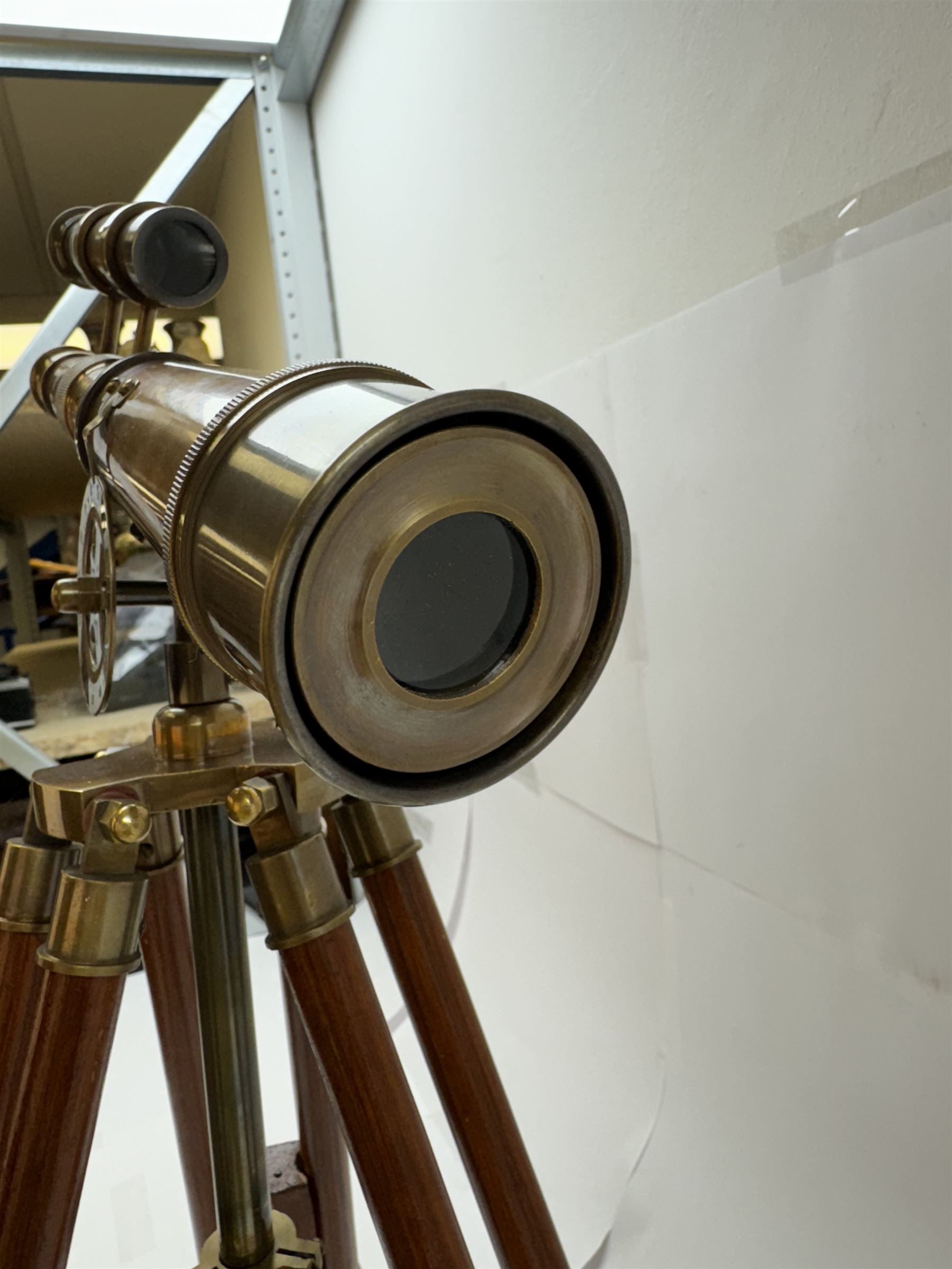 Brass telescope upon a wooden adjustable tripod, H55cm 