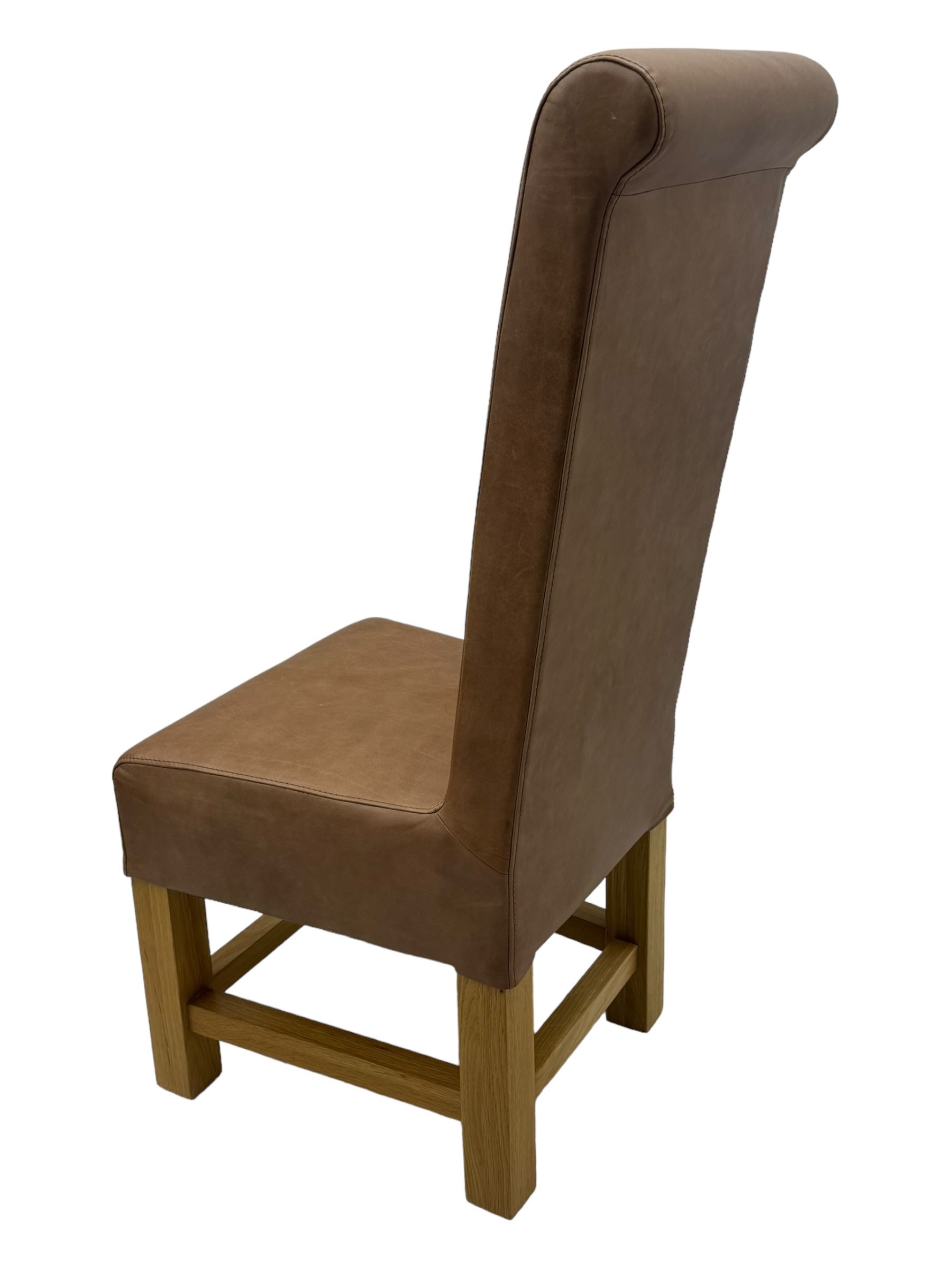 Set of six contemporary light oak dining chairs, each with high back and seat upholstered in pale tan leather, on square supports connected by H-stretcher