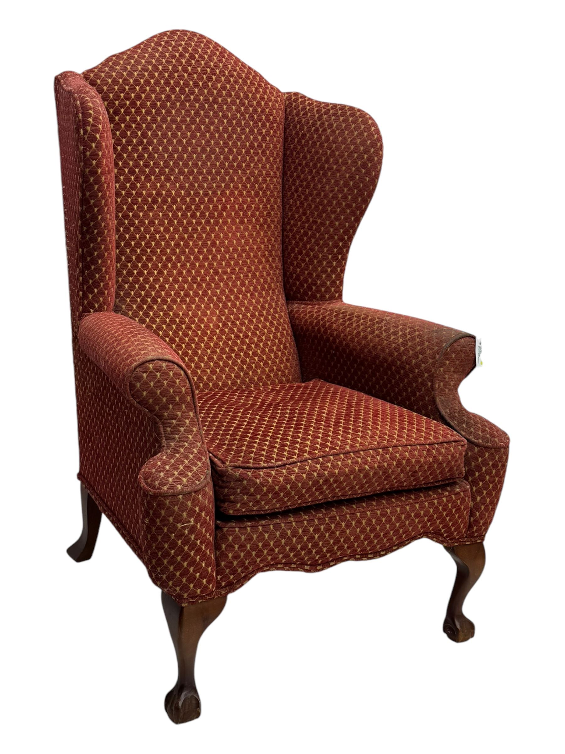 Early 20th century hardwood-framed wingback armchair, upholstered in red dotted fabric, on cabriole feet