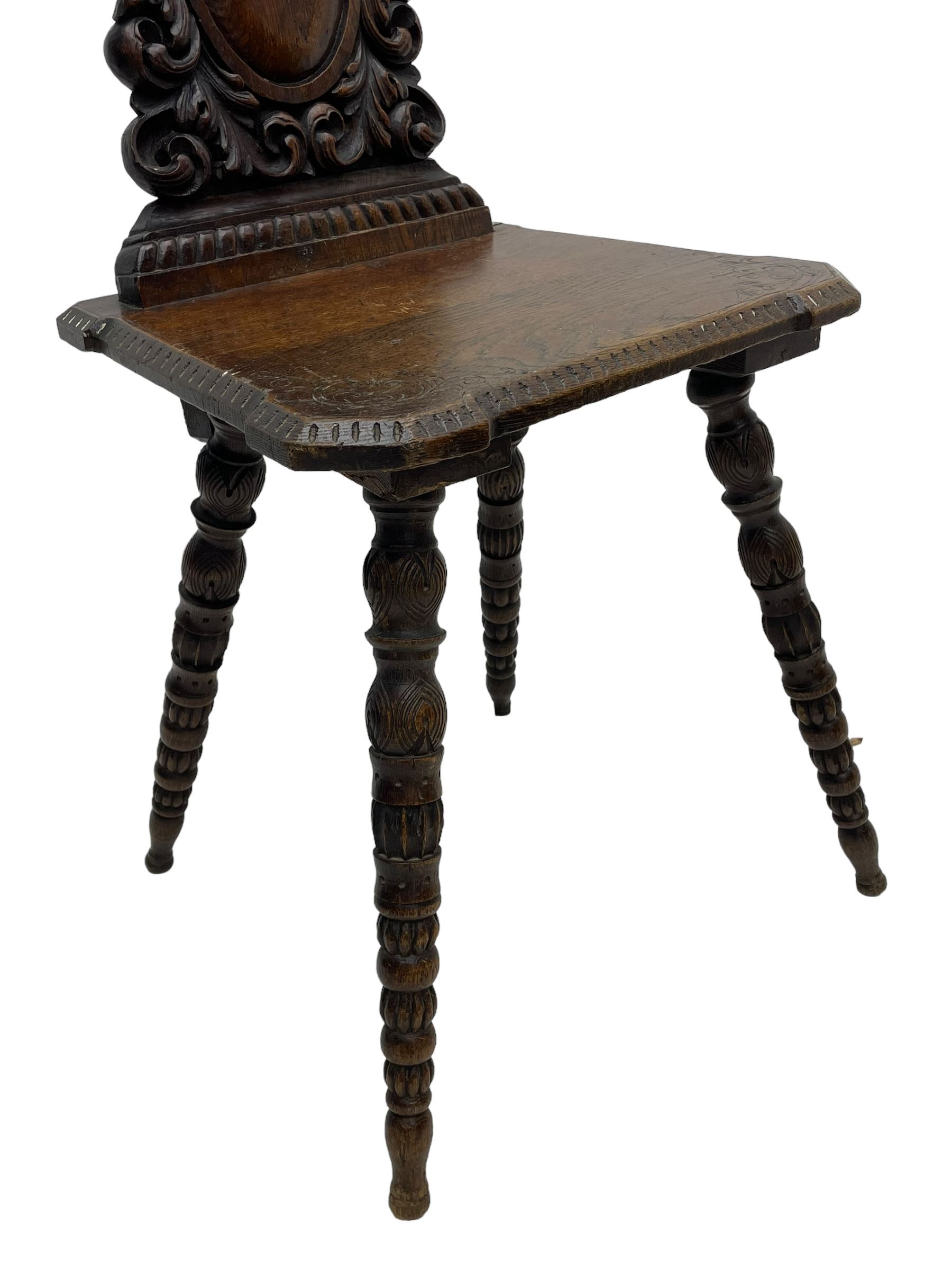 19th century oak hall chair, shaped and pierced back carved with crown cresting over curled and scrolled acanthus leaves, tapered rectangular seat with foliate carved corners and fluted chamfered edge, on turned and lobe carved splayed supports 