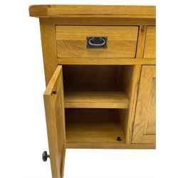 Contemporary light oak sideboard, fitted with three drawers over three panelled cupboards enclosing shelving, on square supports