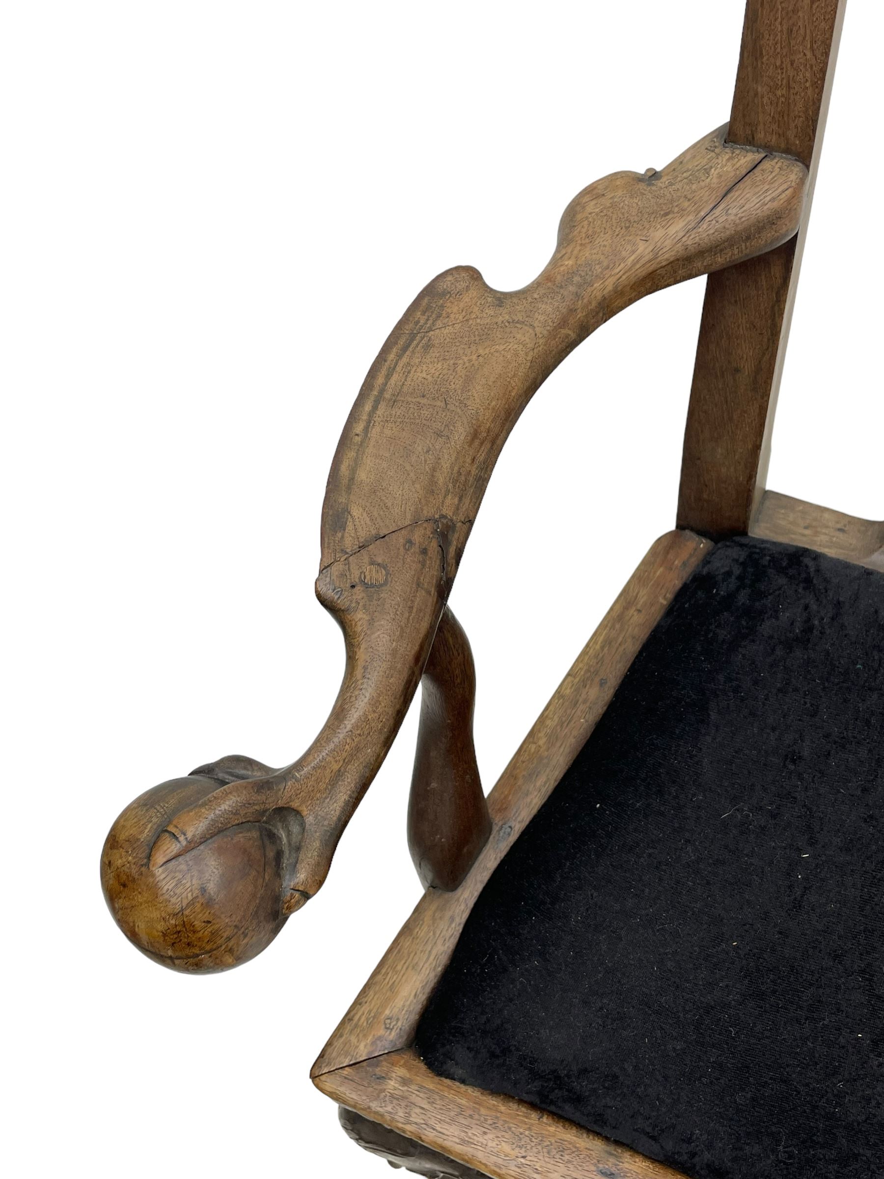 Unusual 18th century mahogany elbow chair, the shaped cresting rail with projecting shell carved ears, pierced and scroll carved splat over drop-in upholstered seat, shaped arms with ball and claw carved terminals, the seat rails carved with shell cartouches, on foliate carved cabriole supports with ball and claw feet 