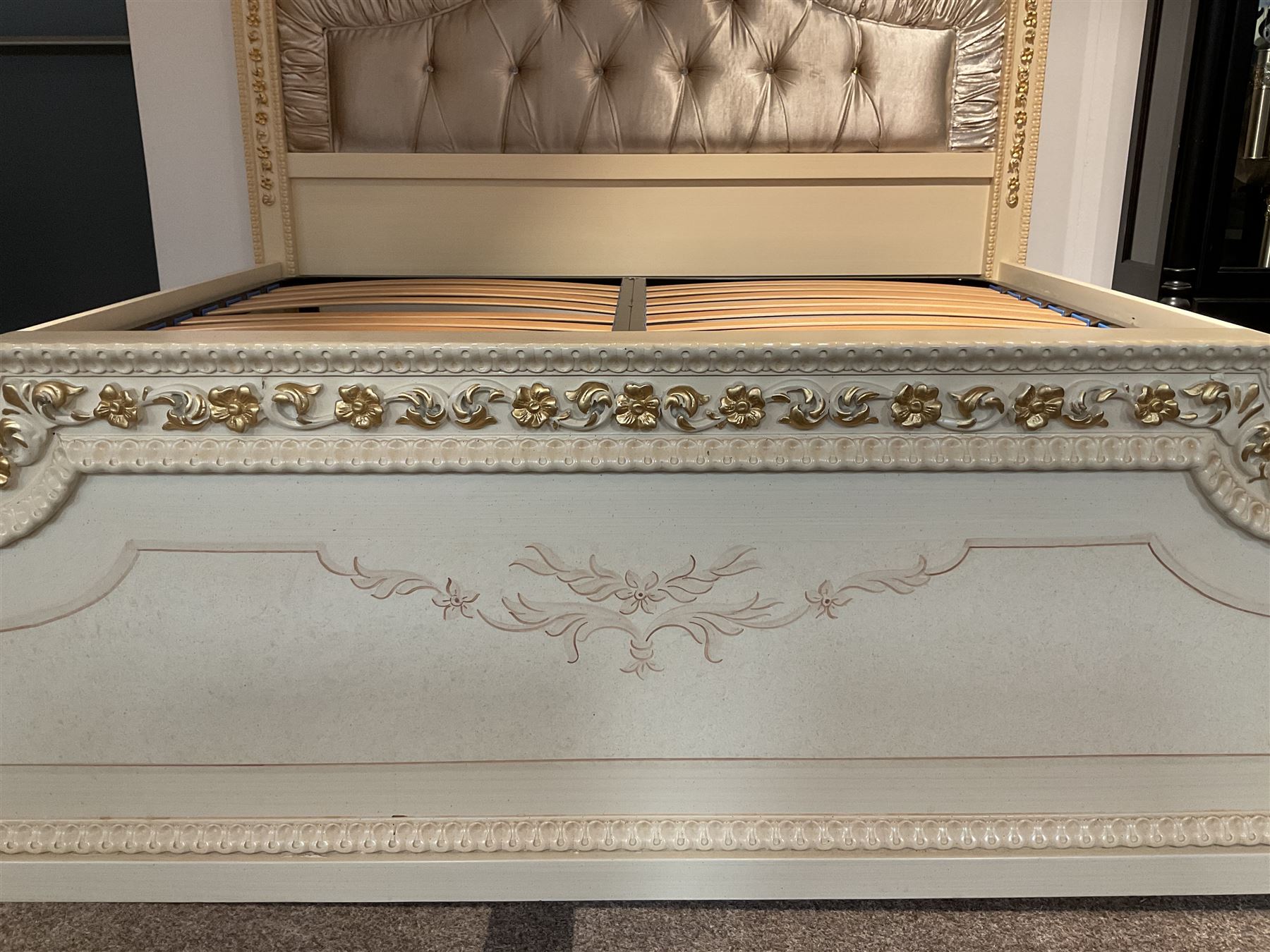 Barnini Oseo - super king 6' 'Reggenza' bedstead, the headboard with a pierced cartouche pediment with extending scrolling foliage, decorated with trailing gilt flower heads, upholstered in buttoned lilac velvet, raised on cabriole feet, in a cream finish