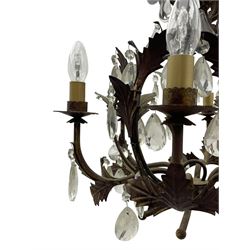 Early 20th century wrought metal chandelier, of scrolled form with six branches, decorated with leafage and glass pendants 