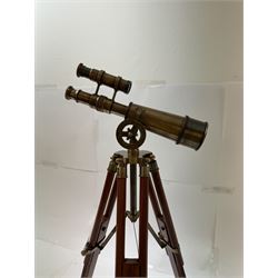 Brass telescope upon a wooden adjustable tripod, H55cm 