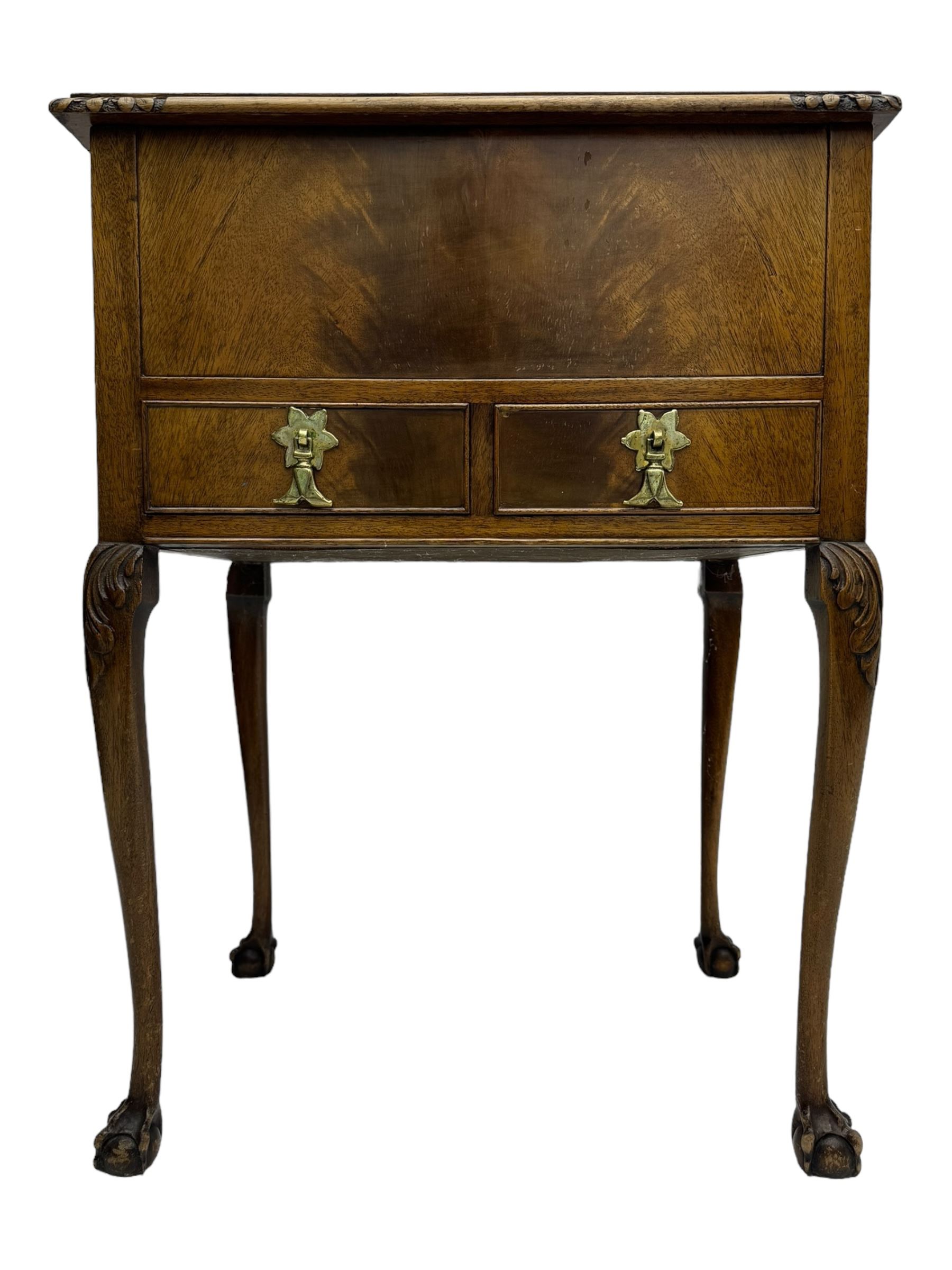 Early 20th century mahogany work table, hinged top enclosing satin-lined compartment with pincushion and pockets, lower section fitted with two drawers with dividers, on cabriole supports with carved knees and claw feet