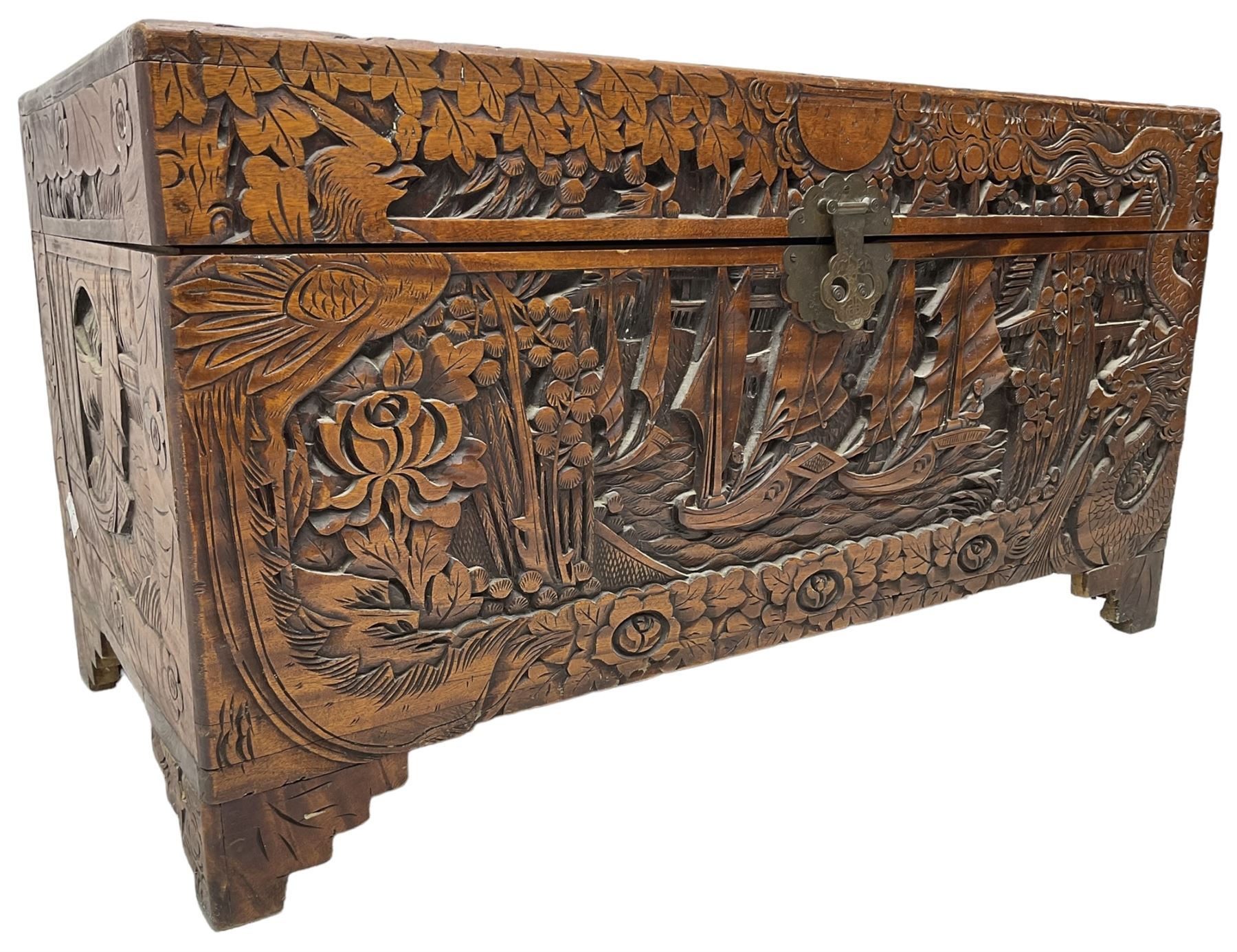 Chinese carved camphor wood blanked chest, rectangular hinged top, carved all over with traditional dragon motifs and junk ships