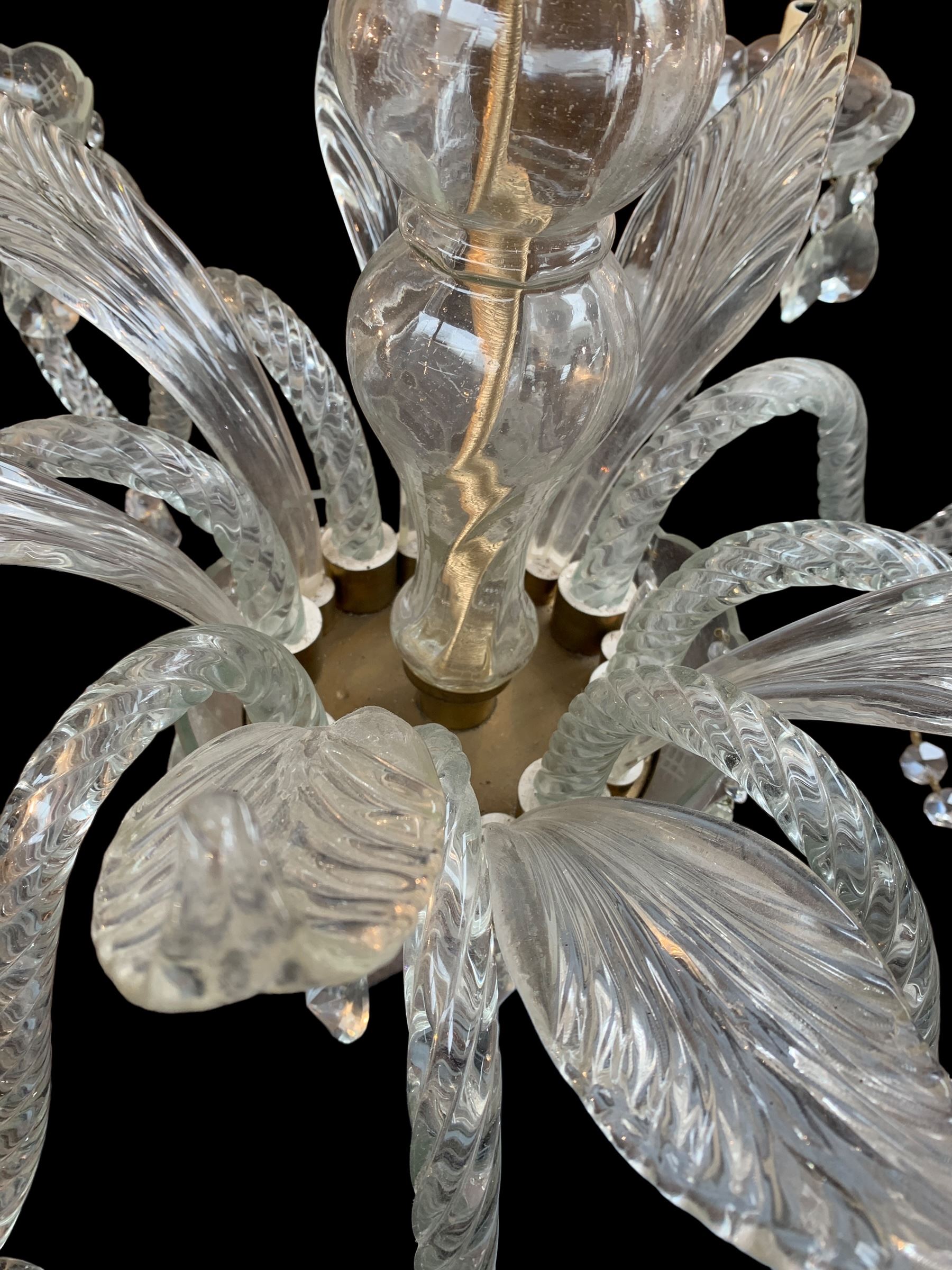 Italian style eight branch glass chandelier, with baluster stem, eight barley twist scroll arms interspersed by seven clear blown glass leaves, petal edged drip pans and hung with faceted glass bead swags and drops, H94cm x W85cm approx.