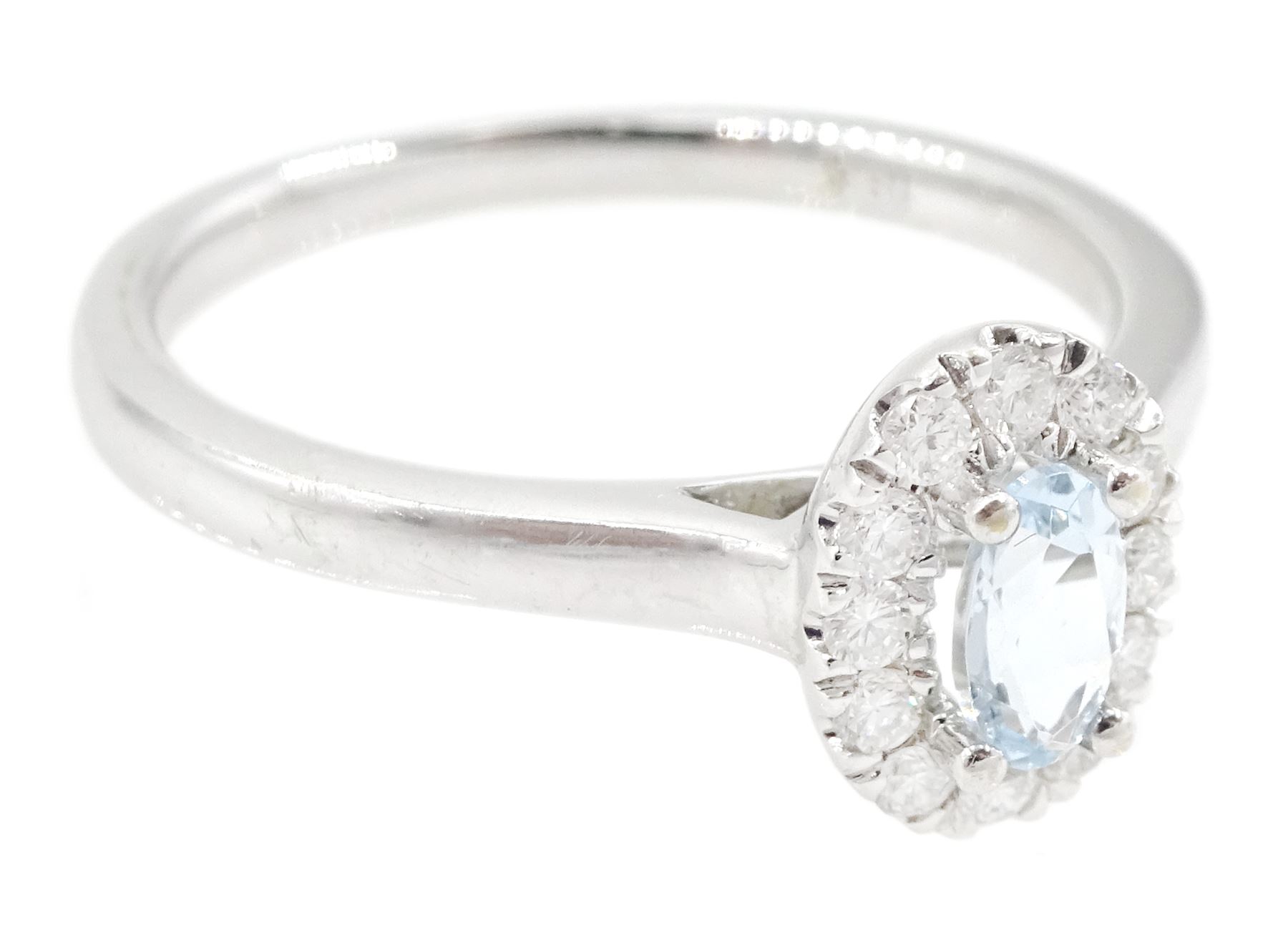 18ct white gold oval cut aquamarine and round brilliant cut diamond cluster ring, Birmingham 2014, total diamond weight approx 0.15 carat