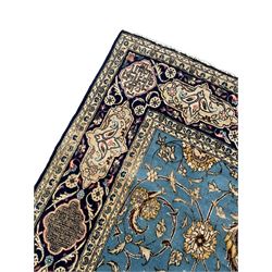 Persian Nain blue ground rug, overall arabesque design, the busy field decorated with interlacing branches and palmettes, indigo ground border with panels decorated with knots and lotus flower motifs, surrounded by trailing branches and flower heads, within guard stripes