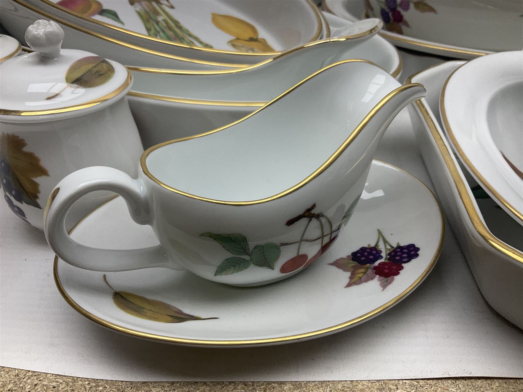 Royal Worcester Evesham pattern, including covered pot de cremes, twin handle tureen, serving dishes, flan dishes, side plates etc  