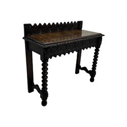 Victorian Gothic revival style carved oak console table, rectangular top with carved edge and raised back gallery, over deeply carved apron with floral and foliate motifs and central drawer, barley twist front supports and plain rear supports united by shaped stretchers, on front bun feet