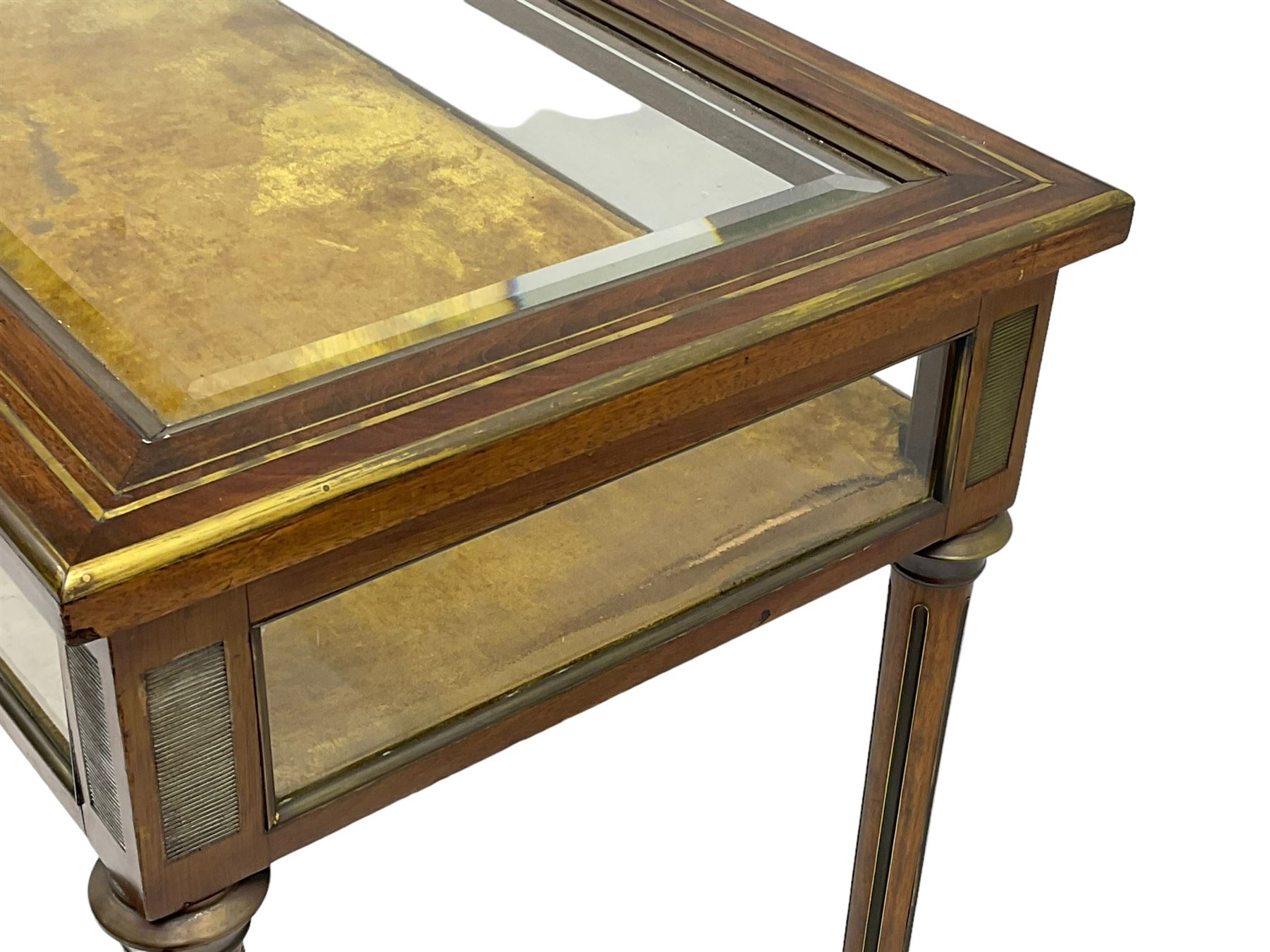 Walnut and brass inlaid bijouterie cabinet, the rectangular lid with bevelled glass pane inlaid with brass stringing, velvet lined interior, on tapering turned and fluted supports with brass collars and feet