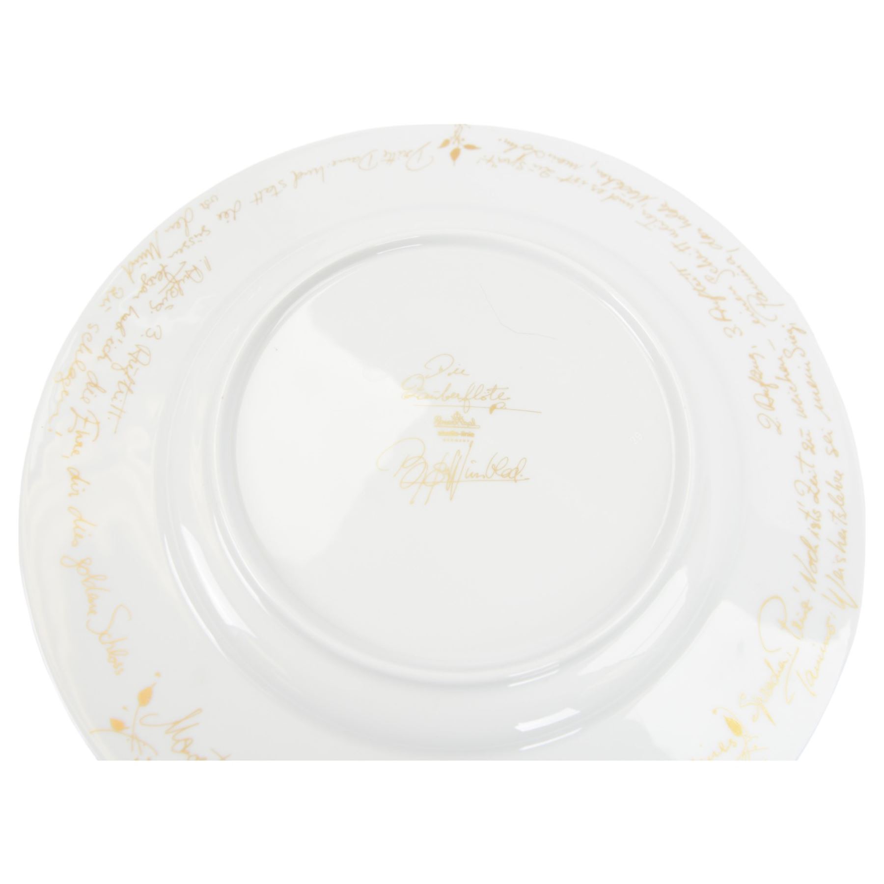 Rosenthal Die Zauberflote pattern dinner plate, designed by Von Bjorn Wiinblad, of circular form the gilt rim decorated in relief with stylised scene's from the Mozart opera,with opera reference inscriptions in German in gilt verso, with printed mark beneath, D32cm