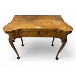 Georgian walnut fold-over card table, shaped rectangular top opening to reveal a baize-lin...