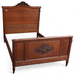 Late 19th century French oak double bedstead, headboard with shaped rail and carved pediment, carved footboard