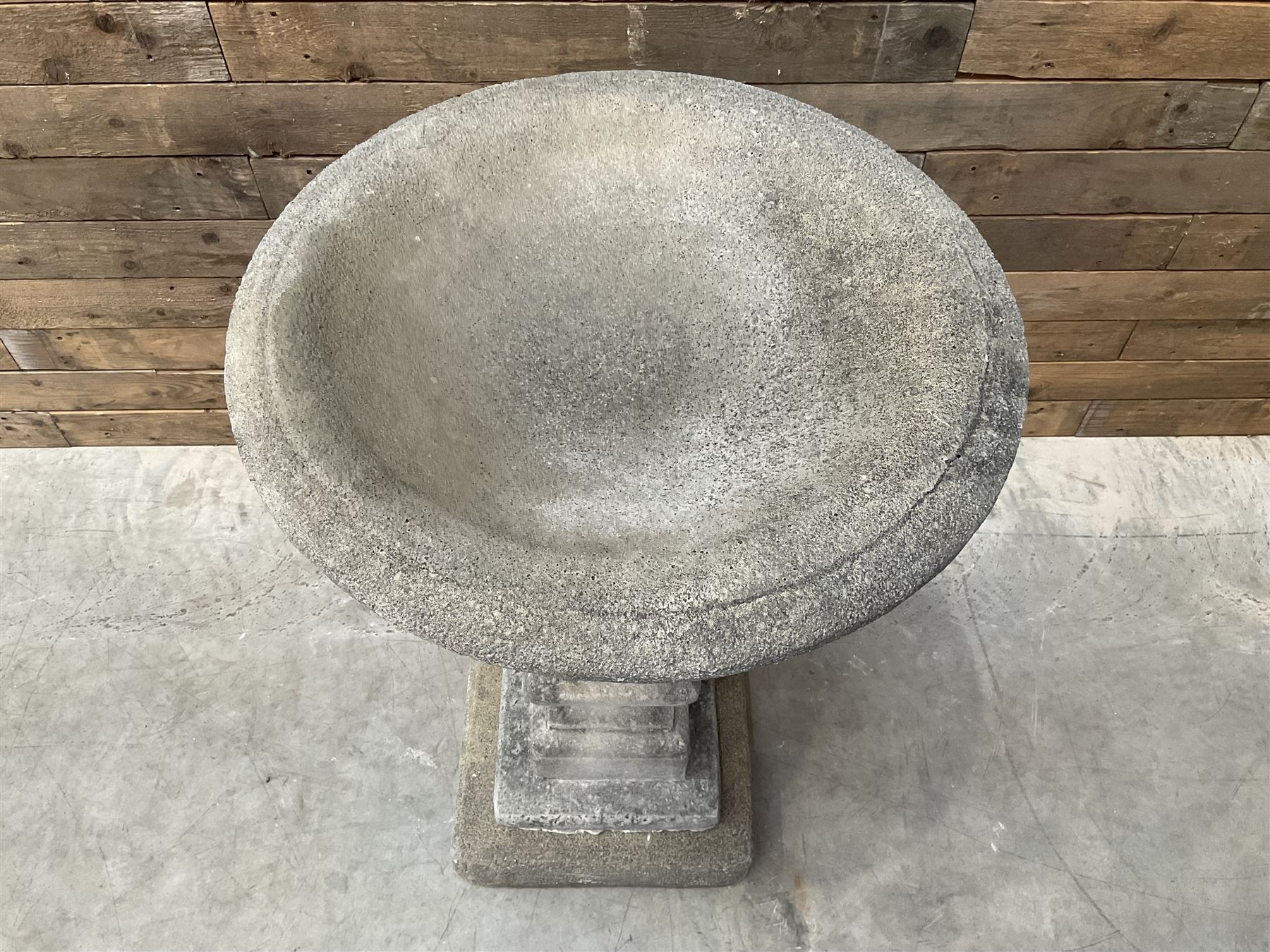 Cast stone garden bird bath, circular dished top, raised on square tapering column, on stepped base with separate mounting plinth