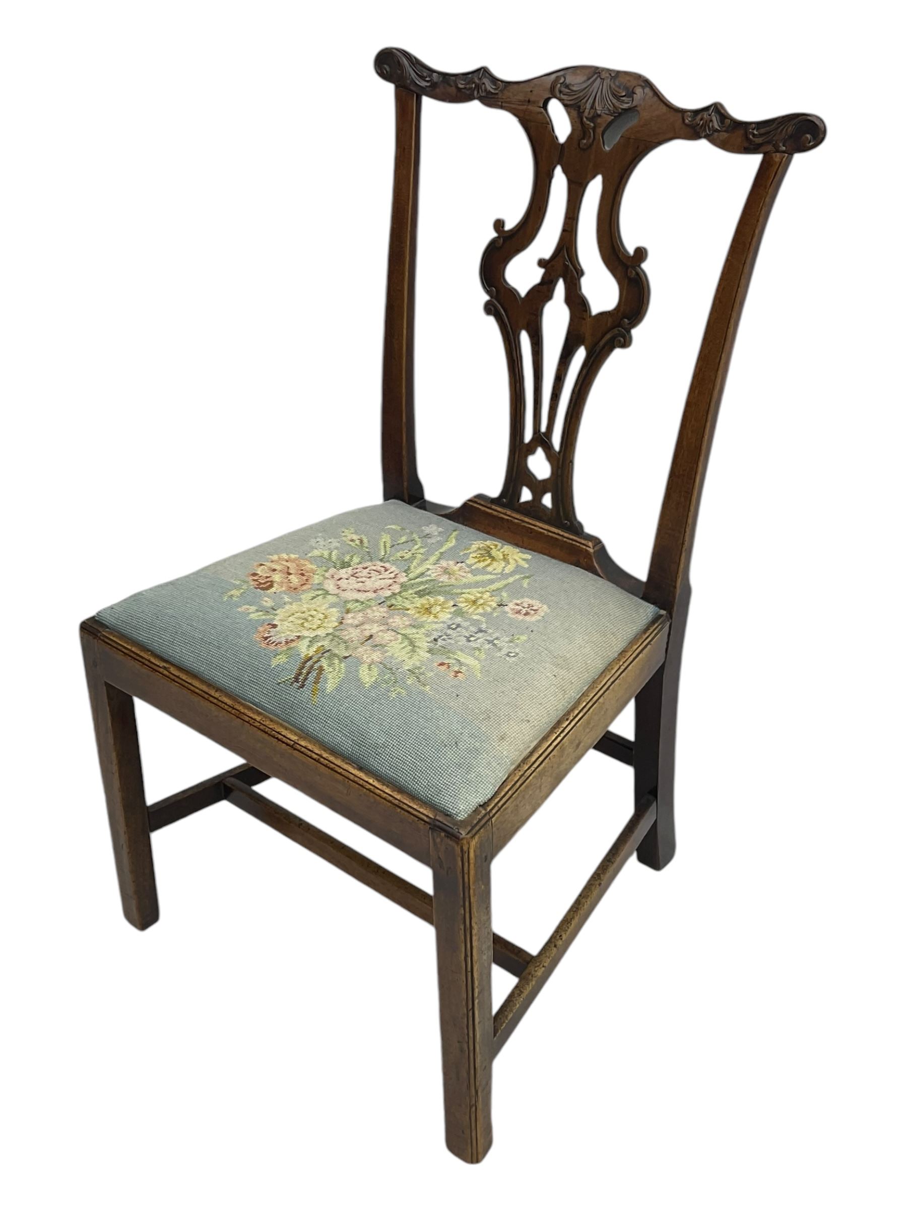 George III Chippendale design dining chair, shaped cresting rail carved with foliate scrolls over pierced and carved splat, floral needle-work upholstered drop-in seat, on square moulded supports united by H-stretchers 