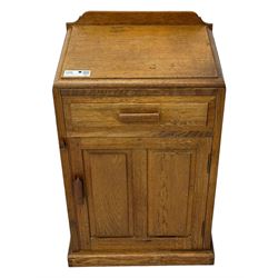 Arts & Crafts period oak bedside cupboard, raised back over moulded top, fitted with single drawer over panelled cupboard, panelled sides, on chamfered plinth base 