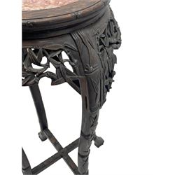 Early 20th century Chinese hardwood plant stand, circular top with marble inset, carved and pierced with interlacing foliage, on leaf carved supports united by x-framed stretchers