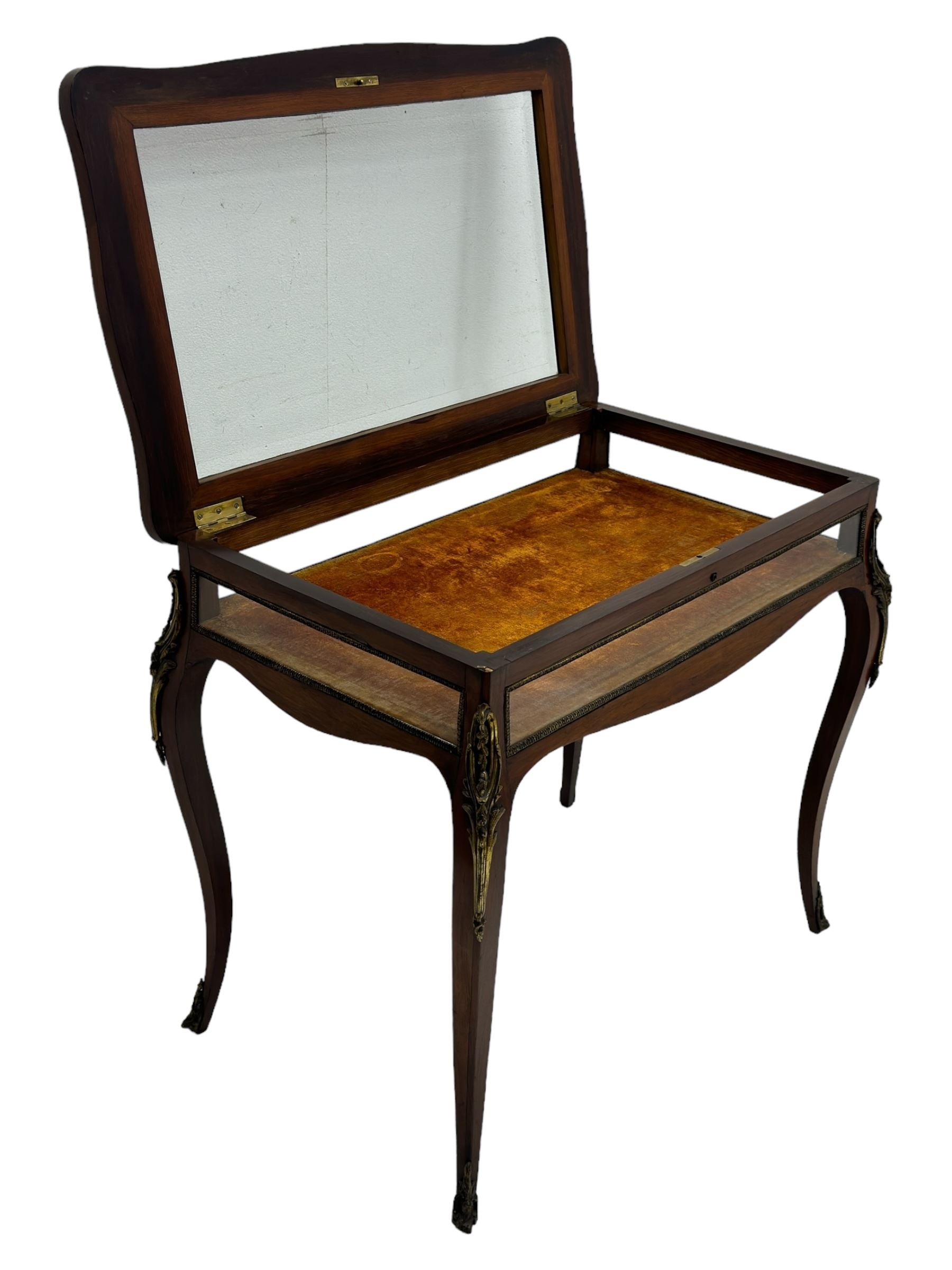 Victorian inlaid rosewood bijouterie table cabinet, shaped form, enclosed by hinged bevel glazed lid with shell and floral inlays, fabric lined interior, glazed sides within foliate cast gilt metal edging, on cabriole supports with floral cast gilt metal mounts and terminal caps 