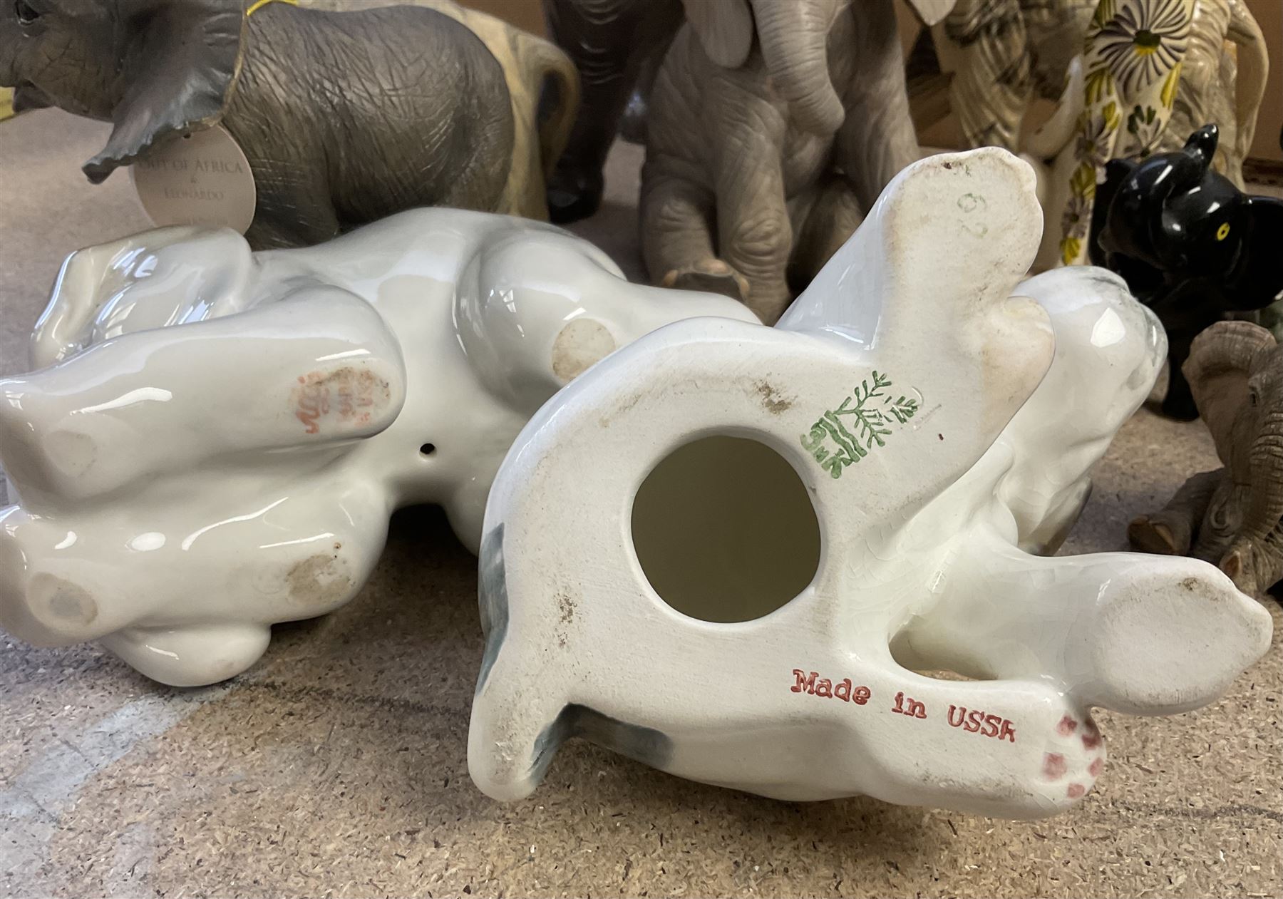 Group of ceramic and resin animal figures, mostly elephants, to include USSR model of a seated Terrier puppy, and a USSR model of a baby elephant, in one box