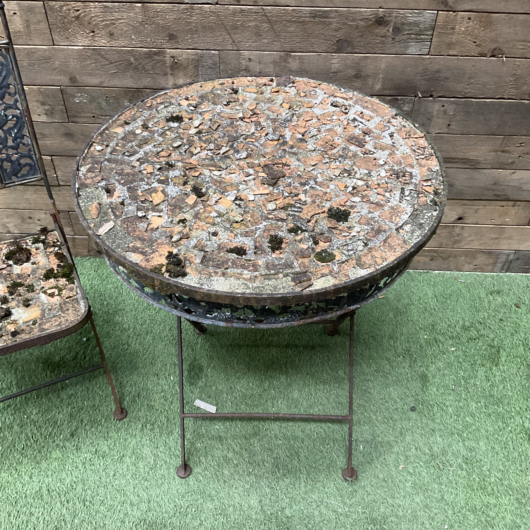 Circular metal garden table with tile top and matching chair, weathered - THIS LOT IS TO BE COLLECTED BY APPOINTMENT FROM DUGGLEBY STORAGE, GREAT HILL, EASTFIELD, SCARBOROUGH, YO11 3TX