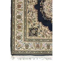 Persian Kirman indigo ground rug, central floral design medallion with matching spandrels, the guarded border decorated with stylised plant motifs 