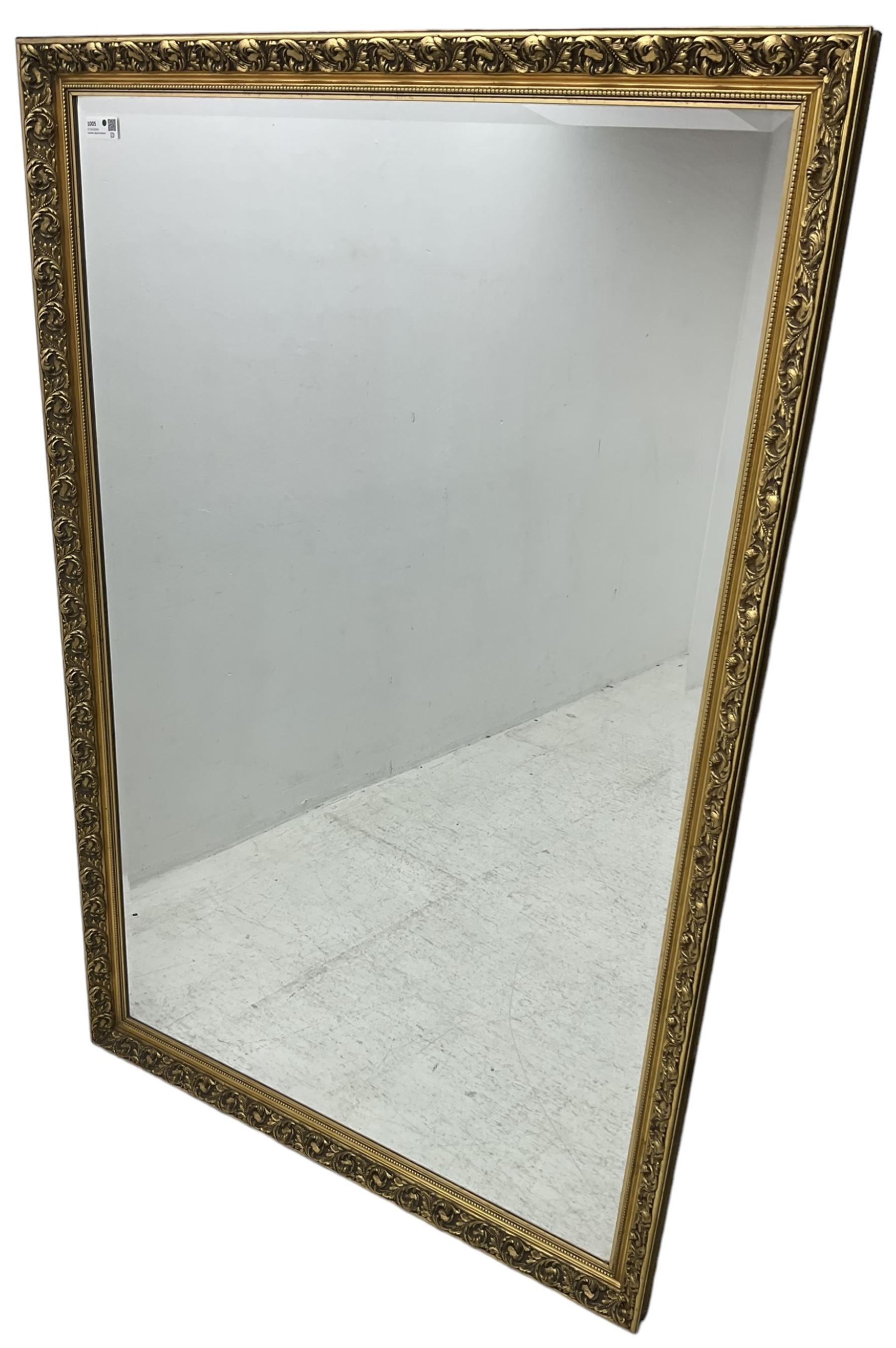 Large rectangular wall mirror, bevelled mirror plate in moulded gilt frame decorated with scrolling foliate 