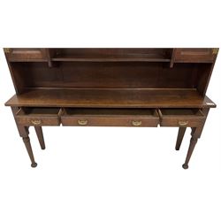 Early 20th century Georgian design oak dresser, projecting cornice with shaped apron over a three-tier plate rack with flanking fielded spice cupboards, the base fitted with three drawers, on turned supports