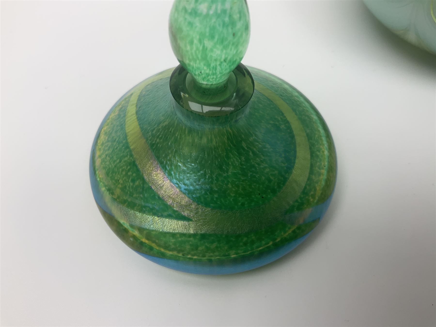 Three Okra scent bottles, the first example decorated with iridescent threads and pulls over a green ground, with a white stopper and two others, largest H18cm