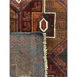 Baluchi red and blue ground rug, the field decorated with large six Gul motifs