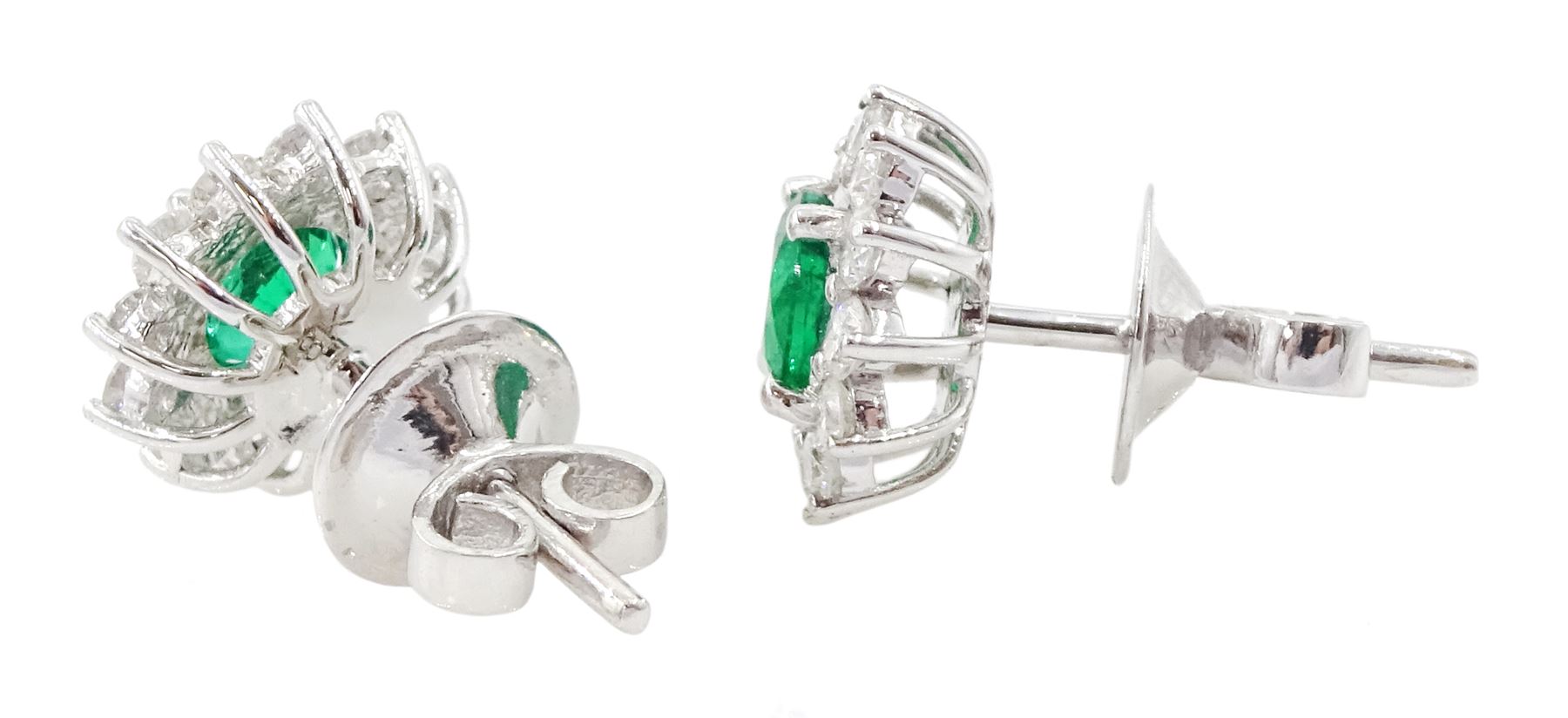 Pair of 18ct white gold emerald and round brilliant cut diamond cluster stud earrings, stamped, total emerald weight approx 0.90 carat, total diamond weight approx 0.65 carat