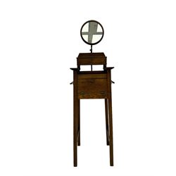 Early 20th century oak vanity stand, with circular adjustable mirror, brass towel rails to the sides, marble inset top and upper compartment, over additional storage compartment with hinged front, on splayed supports with stretchers