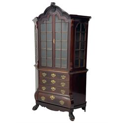 19th century Dutch mahogany vitrine on chest, shaped moulded pediment with central C-scroll and flowerhead carved mount, enclosed by two astragal glazed doors, the interior fitted with fabric lined shelves, four graduating long drawers below, on ball and claw carved feet 