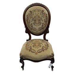 Pair of Victorian walnut lady's and gentleman's drawing room chairs, arched cresting rail carved with cartouche and extending foliage, upholstered in floral pattern fabric, on foliate carved cabriole feet