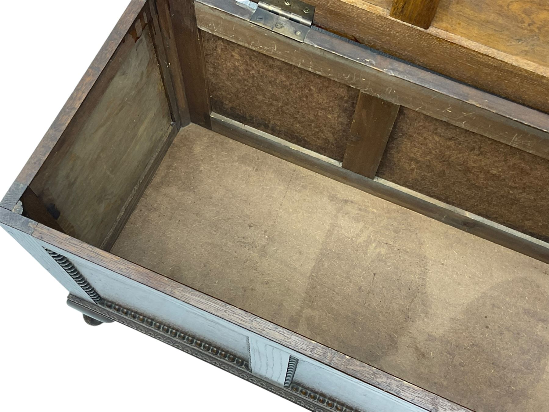 Early 20th century oak blanket chest, rectangular hinged lid with decorative panelling, the front and sides adorned with beaded panels, on cabriole feet