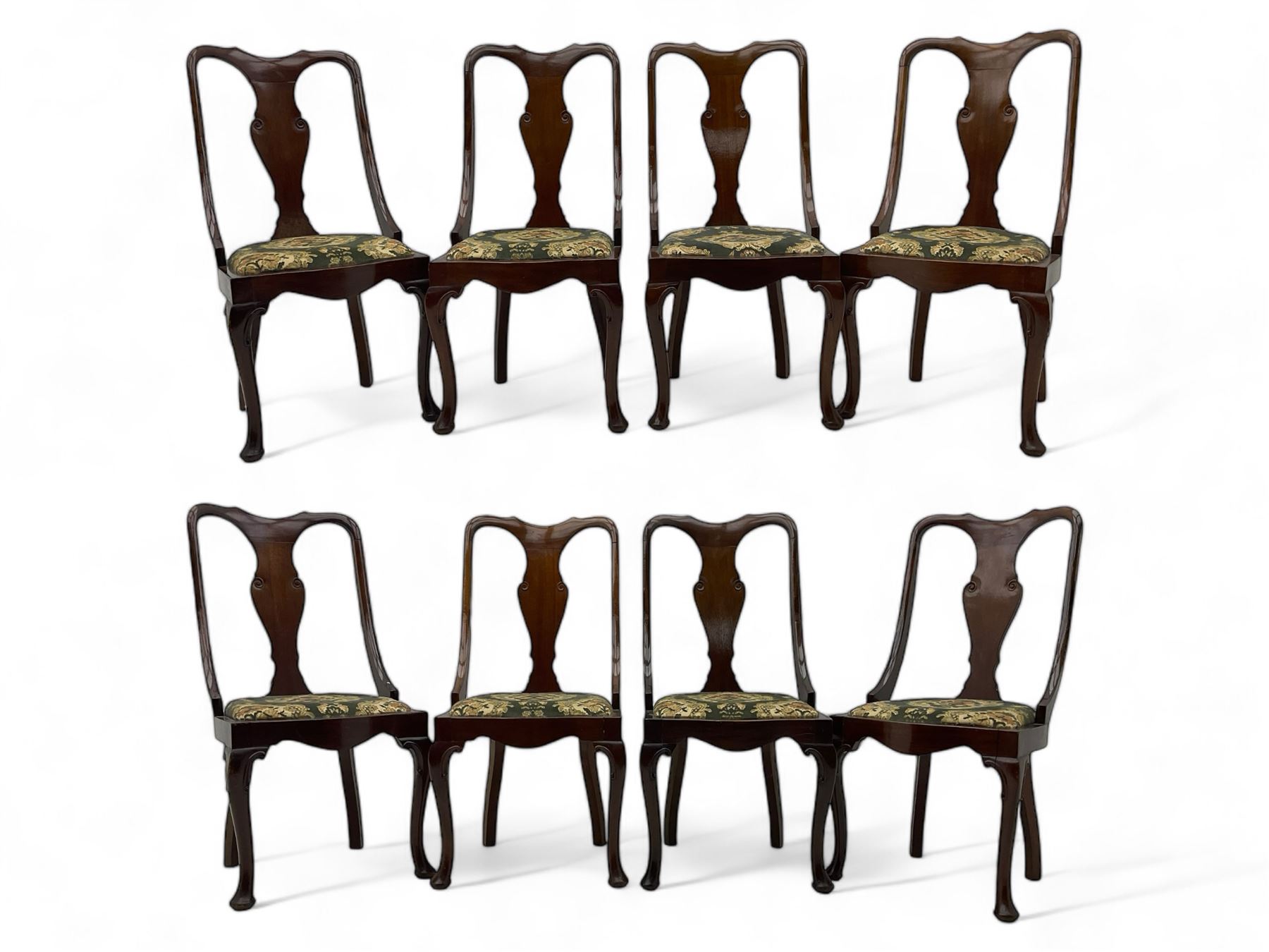 Set of eight late 19th century mahogany spoon back dining chairs, each with shaped top rail over Queen Anne design vase-shaped splat, upholstered seats in floral patterned fabric, raised on cabriole supports with scroll carved knees