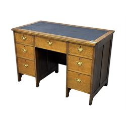 Edwardian oak twin pedestal desk, moulded rectangular top with inset writing surface, fitted with seven drawers, panelled sides, on stile supports 